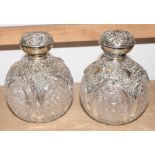 A pair of cut glass and silver mounted scent bottles