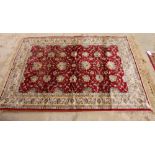 A Kashmir rug decorated palmettes on a red ground, 64" x 46" approx