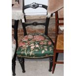 A set of three Victorian ebonised single chairs, stuffed over seats upholstered in a floral print