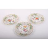 A set of three continental porcelain decorative plates with floral centres and pierced rims, 8"