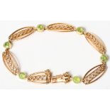 A 15ct gold and peridot gate bracelet, 12.6g