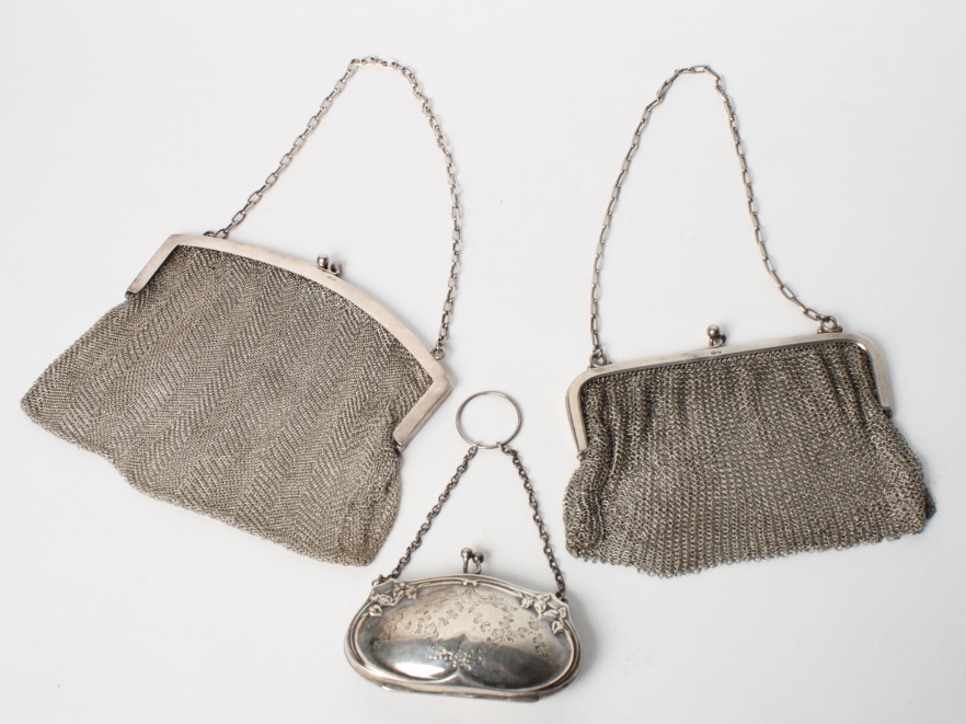 Two silver mesh evening purses and an Edwardian silver purse with engraved decoration