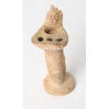 A terracotta fluted oil lamp with figure decoration, 6" high
