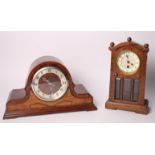 An oak cased mantel clock, door inset three bevelled glass panels, and another mantel clock in