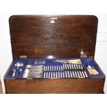 A suite of Elkington silver plated cutlery and flatware, in oak table canteen, on cabriole supports