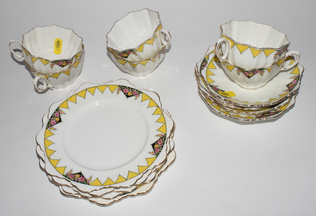 A Paragon china teaset decorated yellow and black with triangular floor panels