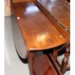 A Georgian mahogany oval drop leaf dining table, on pole turned supports with pad feet, 45" wide