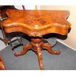 A Victorian burr walnut serpentine fold-over top card table, on turned and carved column and splay