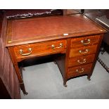 An Edwardian walnut and satinwood banded single pedestal desk with tooled lined top, fitted four