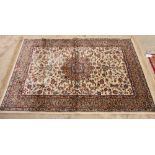 A Kashmir rug decorated Shah Abbas pattern on an ivory ground, 64" x 46" approx
