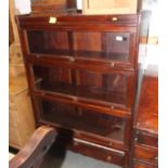 An early 20th Century mahogany bookcase enclosed four glazed up-and-over doors, fitted drawer to