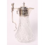 A cut glass and floral engraved claret jug with silver plated mount and cast figural handle