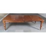 A 19th Century mahogany extending dining table, on turned supports, top 88" x 54" when fully