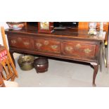 An 18th Century oak dresser base, fitted three deep drawers, on cabriole supports, 72" wide