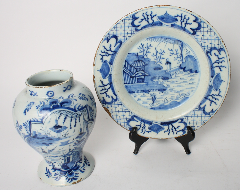 An 18th Century Delft wet drug jar with landscape and foliate decoration and a similar dish