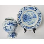 An 18th Century Delft wet drug jar with landscape and foliate decoration and a similar dish