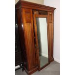 A late 19th Century walnut wardrobe enclosed central mirror door, 50" wide
