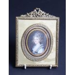 A late Victorian gilt metal miniature frame with silk lining