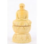 A Japanese carved bone figure of a seated Buddha