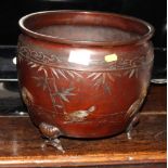 A Japanese bronze jardinière with applied brass decoration with chickens, raised on lotus supports