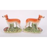 A pair of 19th Century Staffordshire standing greyhounds, 7" high