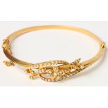 An Edwardian 15ct gold and seed pearl bracelet with floral decoration, 8g