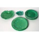 A set of six Wedgwood green glazed leaf plates and four similar plates/dishes (some damages)