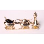 A silver three-piece cruet on matching tray