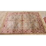 A Kashmir rug decorated stylised floral panels on a gold ground, 64" x 46" approx