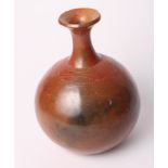 An African polished red clay bottle vase, 8 1/2" high
