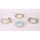 Four Shelley china trios with floral and scrolled banded decoration
