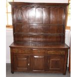 A Georgian oak dresser, fitted plate shelves over three drawers and two cupboards enclosed