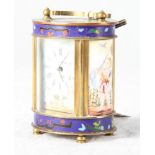 A French carriage timepiece in oval brass case with floral champlevé enamel decoration, porcelain