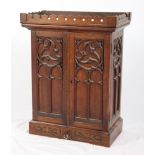 A collector's late 19th Century oak Gothic blind fretted work cabinet, the interior fitted seven