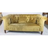 A late Victorian Chesterfield settee, on square castored supports, 70" wide
