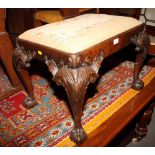 A carved mahogany dressing stool of mid Georgian design, on acanthus leaf and cabriole claw and ball