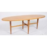 A Gordon Russell light wood oval coffee table, on tapered supports, 48" wide
