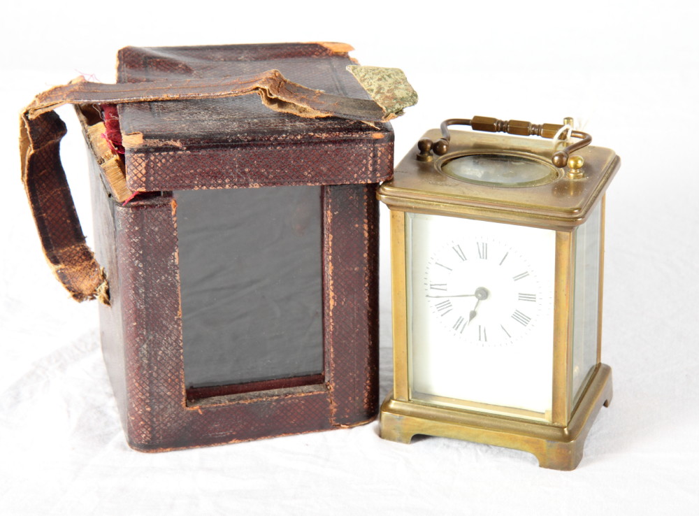 A French carriage timepiece in brass case, white enamel dial, in leather travelling case