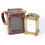 A French carriage timepiece in brass case, white enamel dial, in leather travelling case