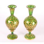 A pair of continental green and gilt scroll decorated bulbous vases, 9 1/2" high