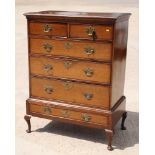 An 18th Century oak and mahogany banded chest of two small and three long graduated drawers, on