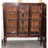 A polished as mahogany bowfront display cabinet enclosed three leaded glazed doors, on cabriole