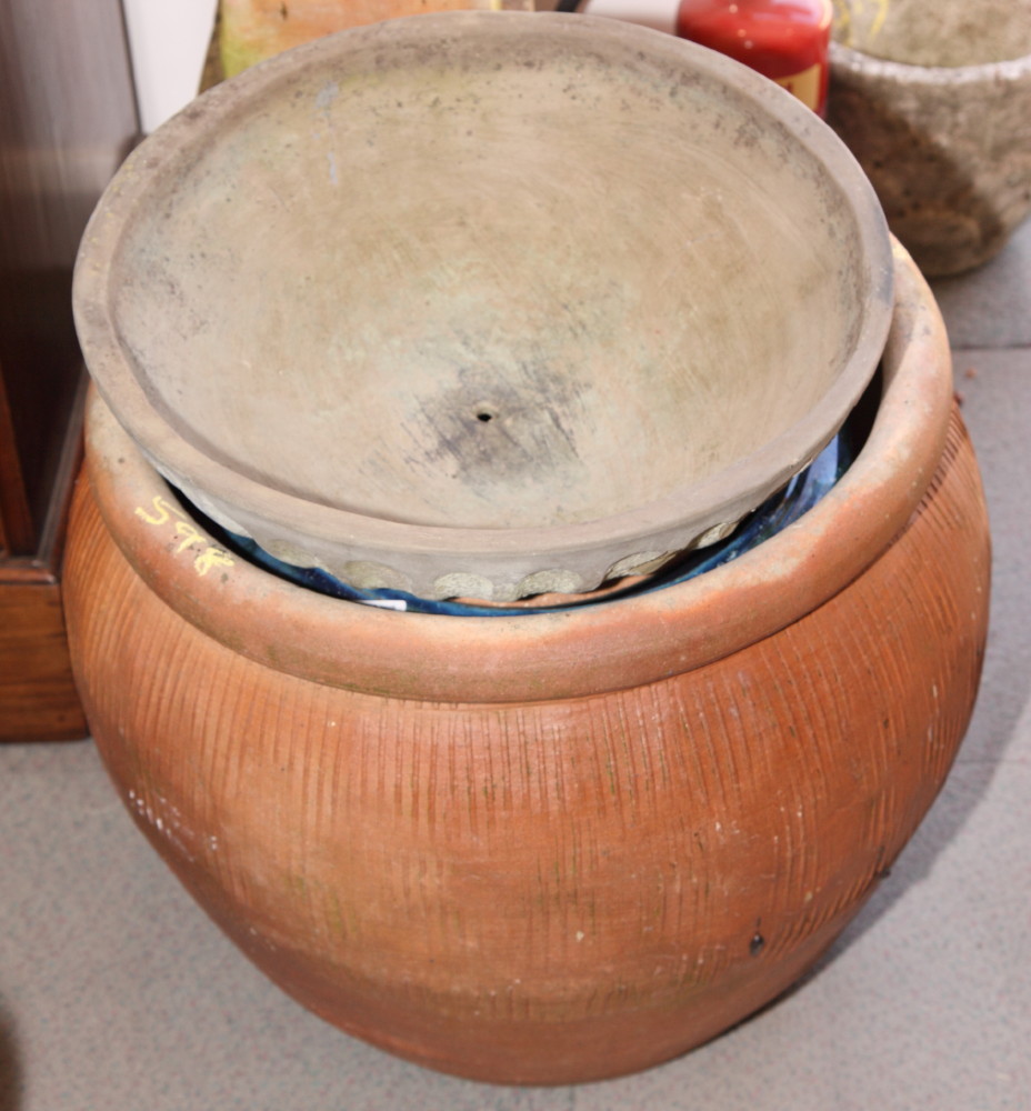 An oviform garden planter and a blue glazed garden planter and one other