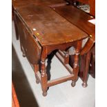 A 17th Century oval open drop leaf dining table, on block turned supports, 44" wide