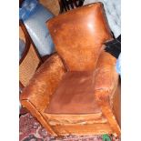 A pair of 1930s brown leather armchairs, on square taper supports