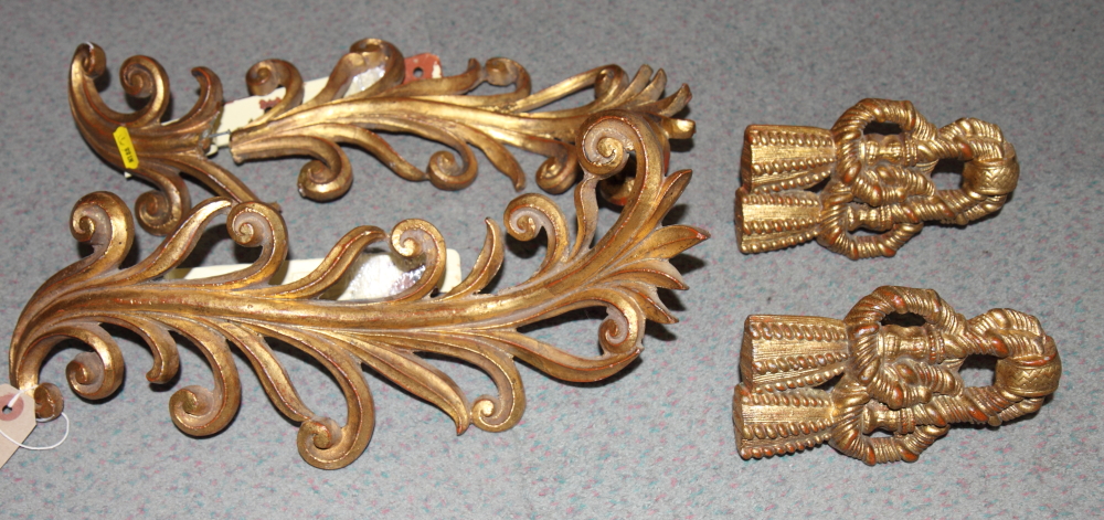 A pair of gilt metal scrollwork curtain tiebacks and a similar pair (restored)