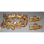 A pair of gilt metal scrollwork curtain tiebacks and a similar pair (restored)