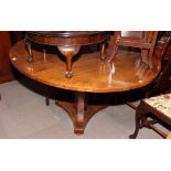 An oak oval  dining table, on octagonal pillar and triangular platform base