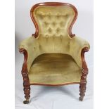 A Victorian walnut showframe armchair, button upholstered in an old gold fabric, on turned and