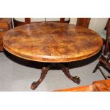 A Victorian figured walnut loo table, base fitted four turned spindles, on splayed supports, 52" x